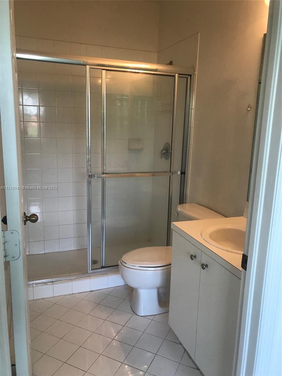 Malibu Bay Homestead, FL 33033 - Photo 11 of 12 a bathroom with a granite countertop toilet and a shower