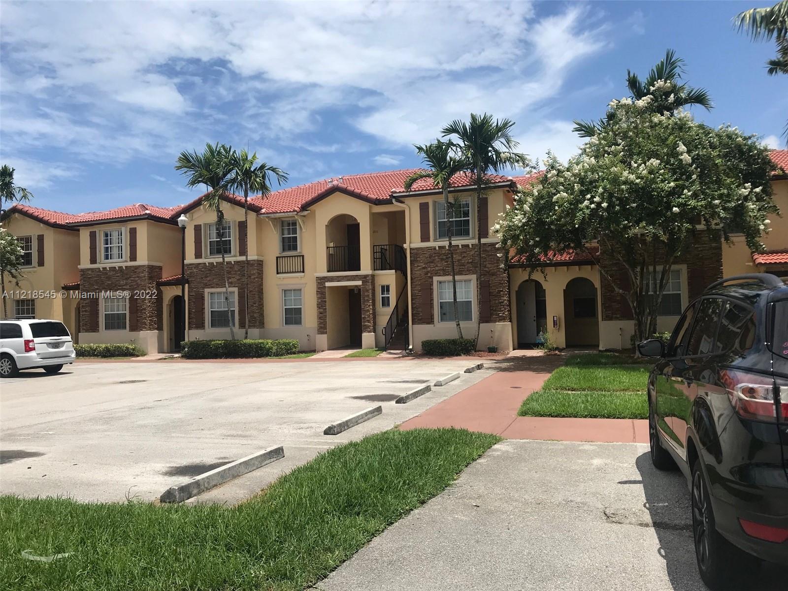 Malibu Bay Homestead, FL 33033 - Photo 5 of 12 a front view of a house with a yard and garage