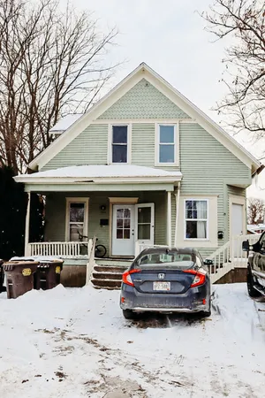 a car parked in front of white house