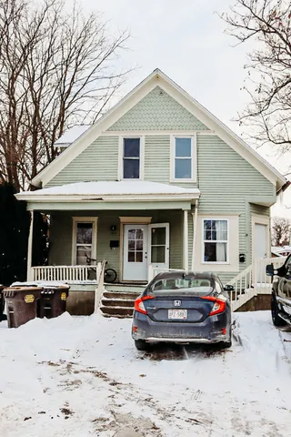 a car parked in front of white house