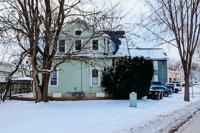 a view of a house with a snow in the yard