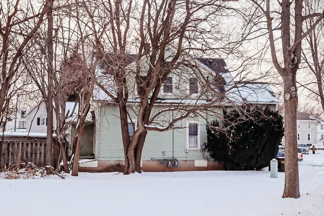 a view of a house with a snow in the yard