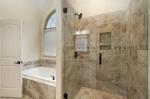 a bathroom with a bathtub and shower