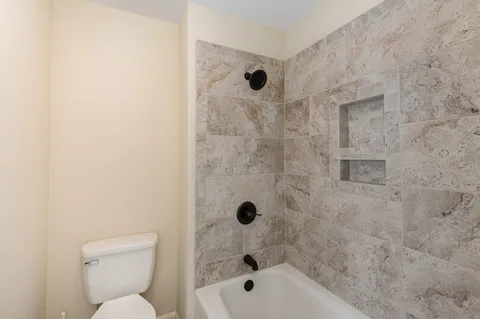 a bathroom with a bathtub and a toilet