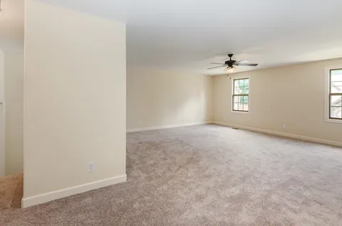 an empty room with windows and closet