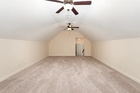 a view of a room with a ceiling fan