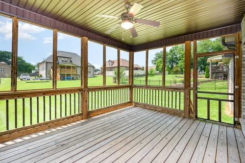 a view of a porch with wooden floor