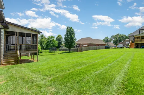 a view of a house with a backyard
