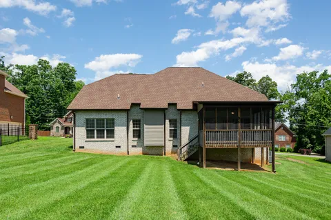 a view of a house with a backyard porch and sitting area