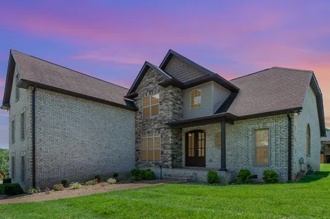 a front view of a house with a garden