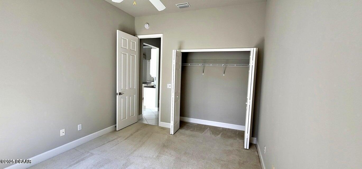 1070 Hampstead Lane Ormond Beach, FL 32174 - Photo 11 of 18 an empty room that has a glass door and closet