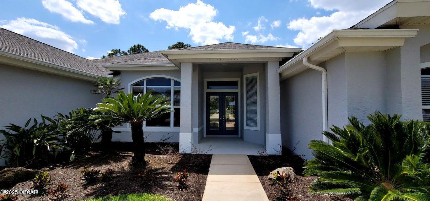 1070 Hampstead Lane Ormond Beach, FL 32174 - Photo 3 of 18 a view of a porch with potted plants and couches