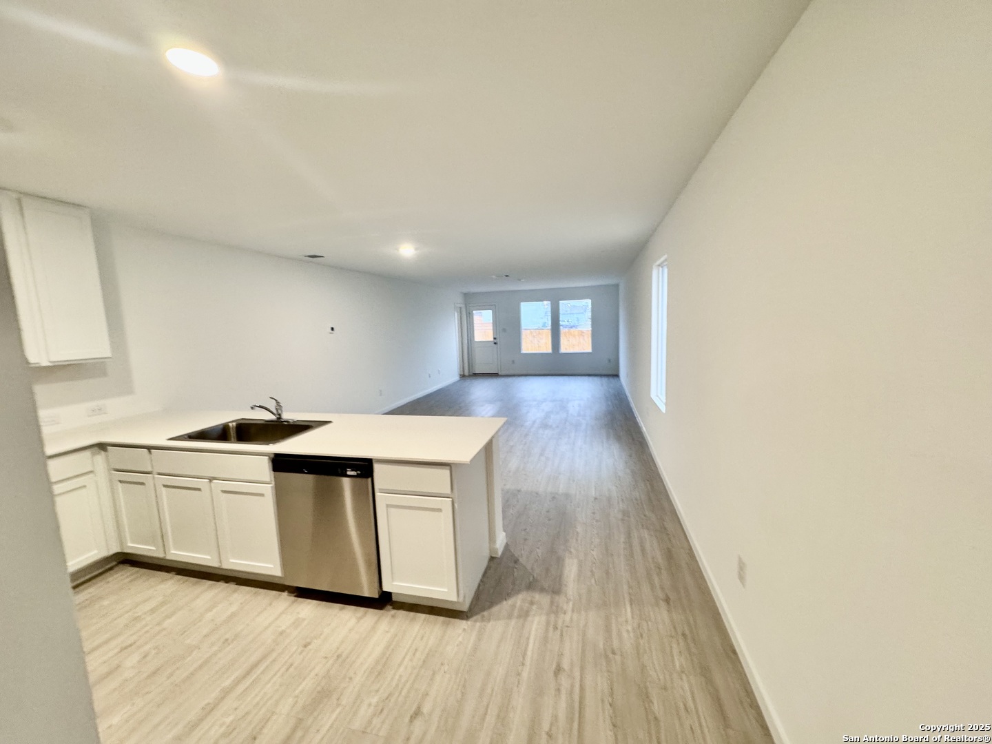 5151 Yancy Creek Converse, TX 78109 - Photo 6 of 17 a kitchen with stainless steel appliances granite countertop a sink and wooden floors