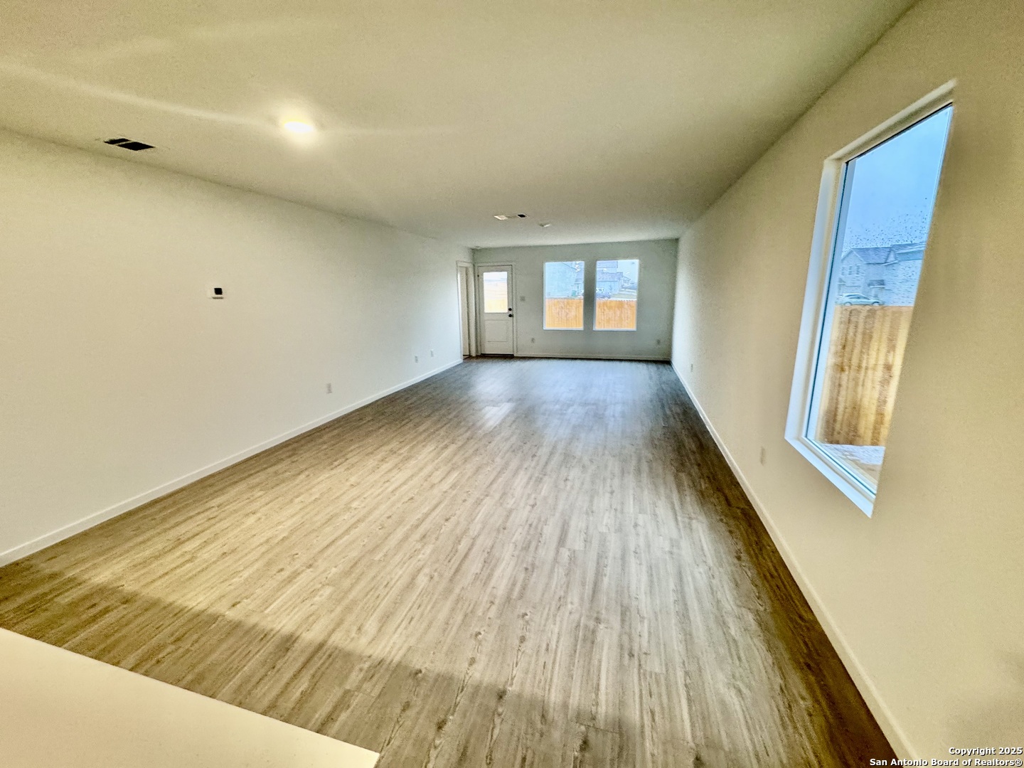 5151 Yancy Creek Converse, TX 78109 - Photo 7 of 17 a view of an empty room with wooden floor and a window