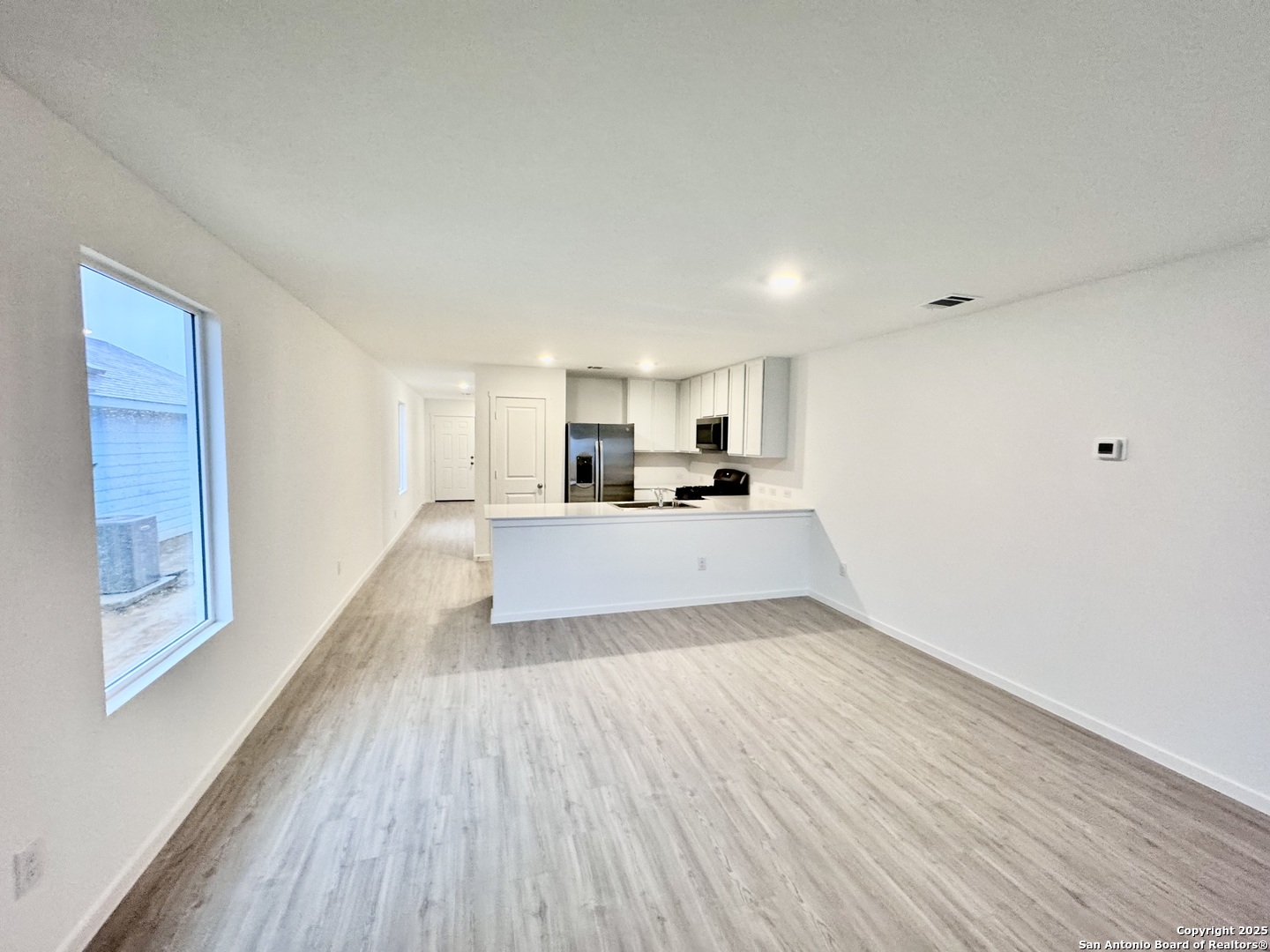 5151 Yancy Creek Converse, TX 78109 - Photo 8 of 17 a big room with wooden floor and windows
