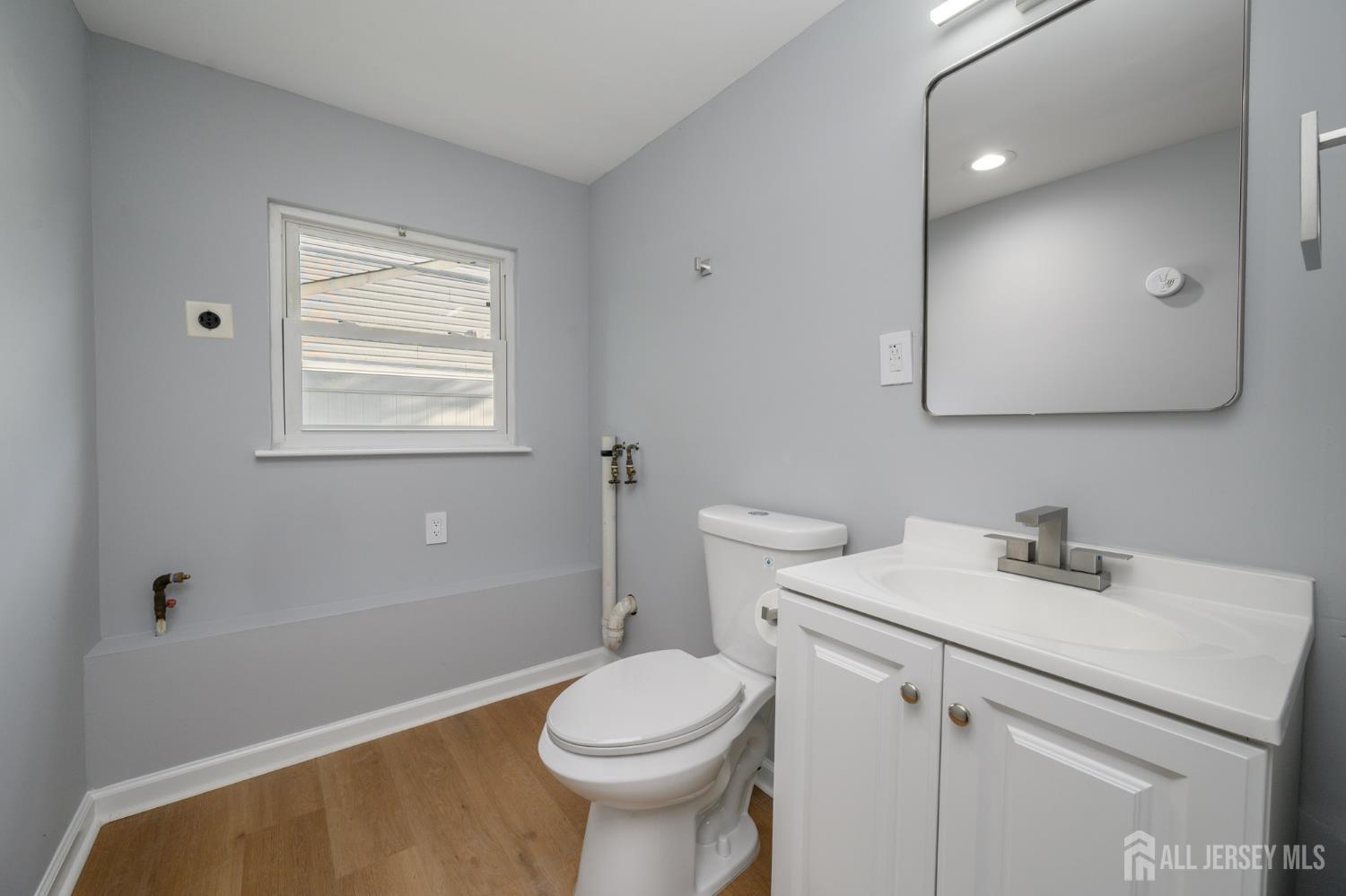 56 Drake Place Colonia, NJ 07067 - Photo 13 of 31 a bathroom with a sink a toilet and vanity