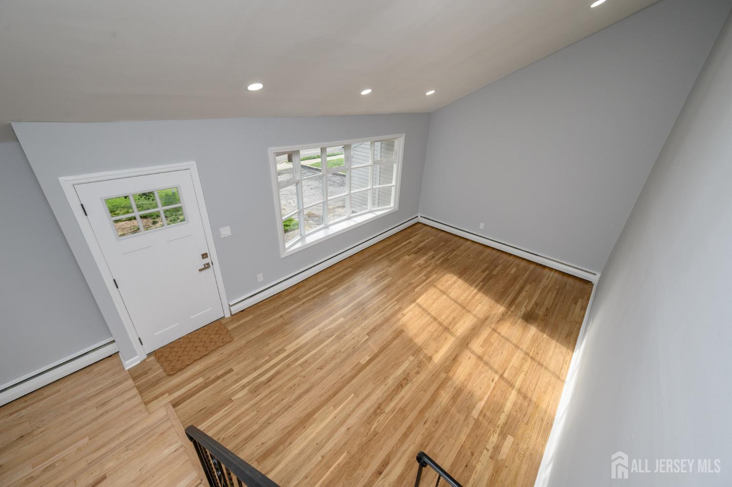 56 Drake Place Colonia, NJ 07067 - Photo 15 of 31 an empty room with wooden floor and windows