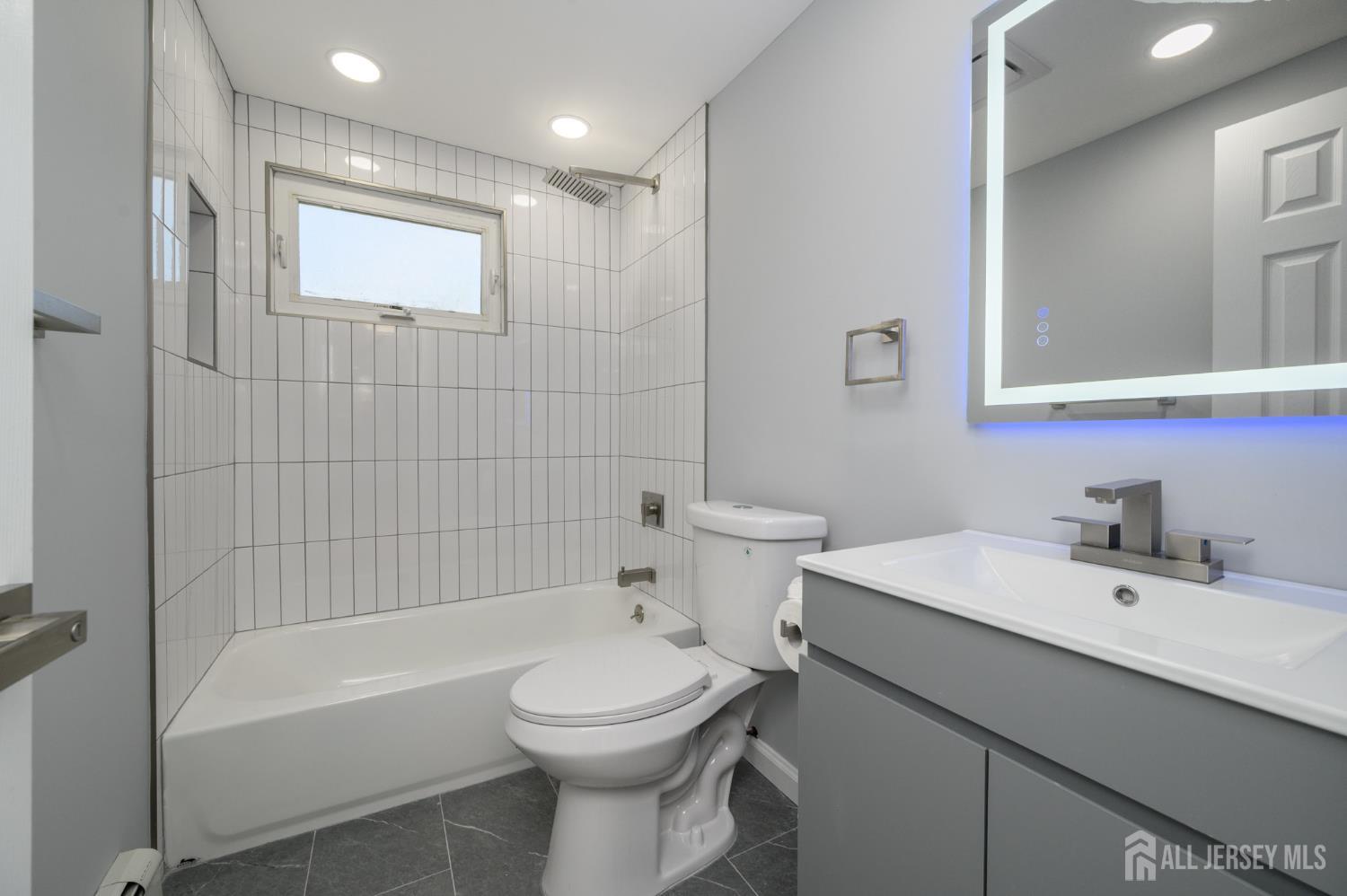 56 Drake Place Colonia, NJ 07067 - Photo 16 of 31 a bathroom with a sink a toilet and shower