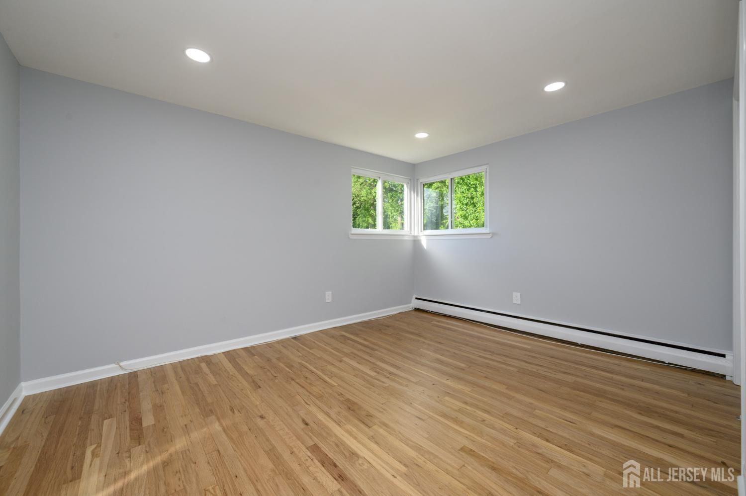 56 Drake Place Colonia, NJ 07067 - Photo 21 of 31 a view of an empty room with wooden floor and a window