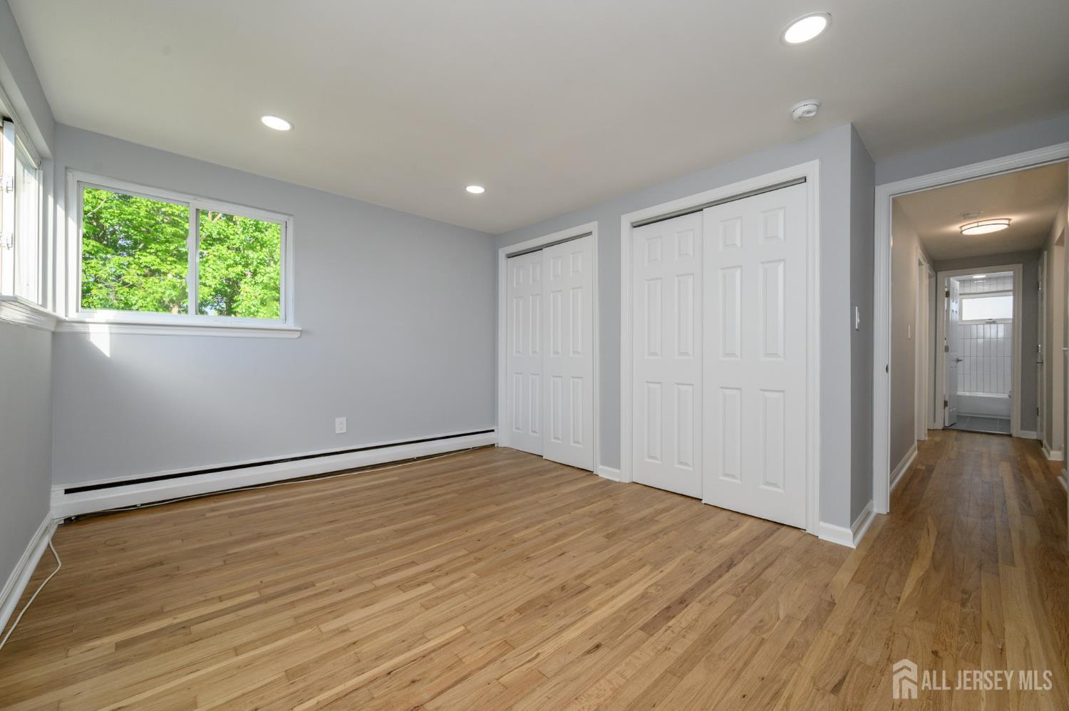 56 Drake Place Colonia, NJ 07067 - Photo 22 of 31 a view of an empty room with wooden floor and a window