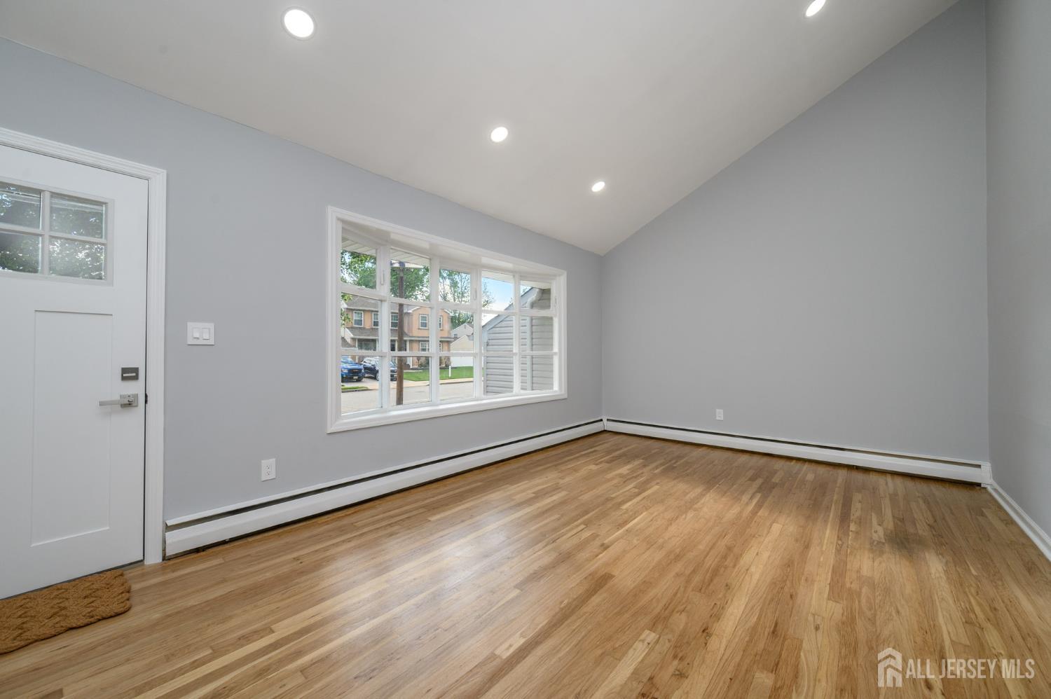 56 Drake Place Colonia, NJ 07067 - Photo 4 of 31 wooden floor in an empty room with a window