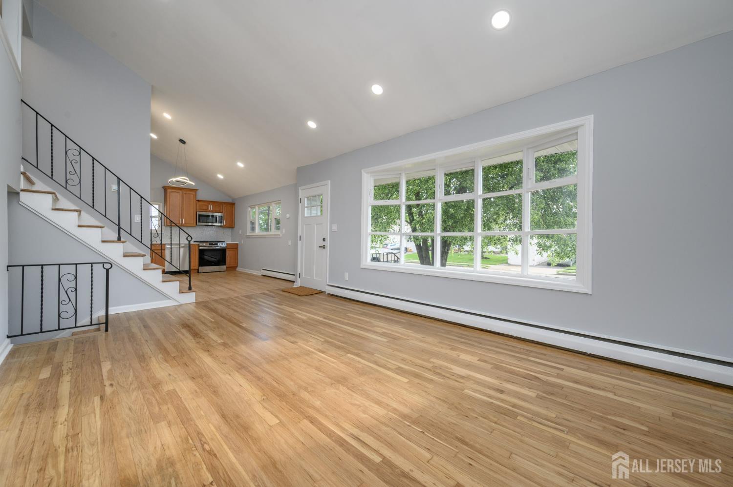 56 Drake Place Colonia, NJ 07067 - Photo 5 of 31 a view of an empty room with wooden floor and a window