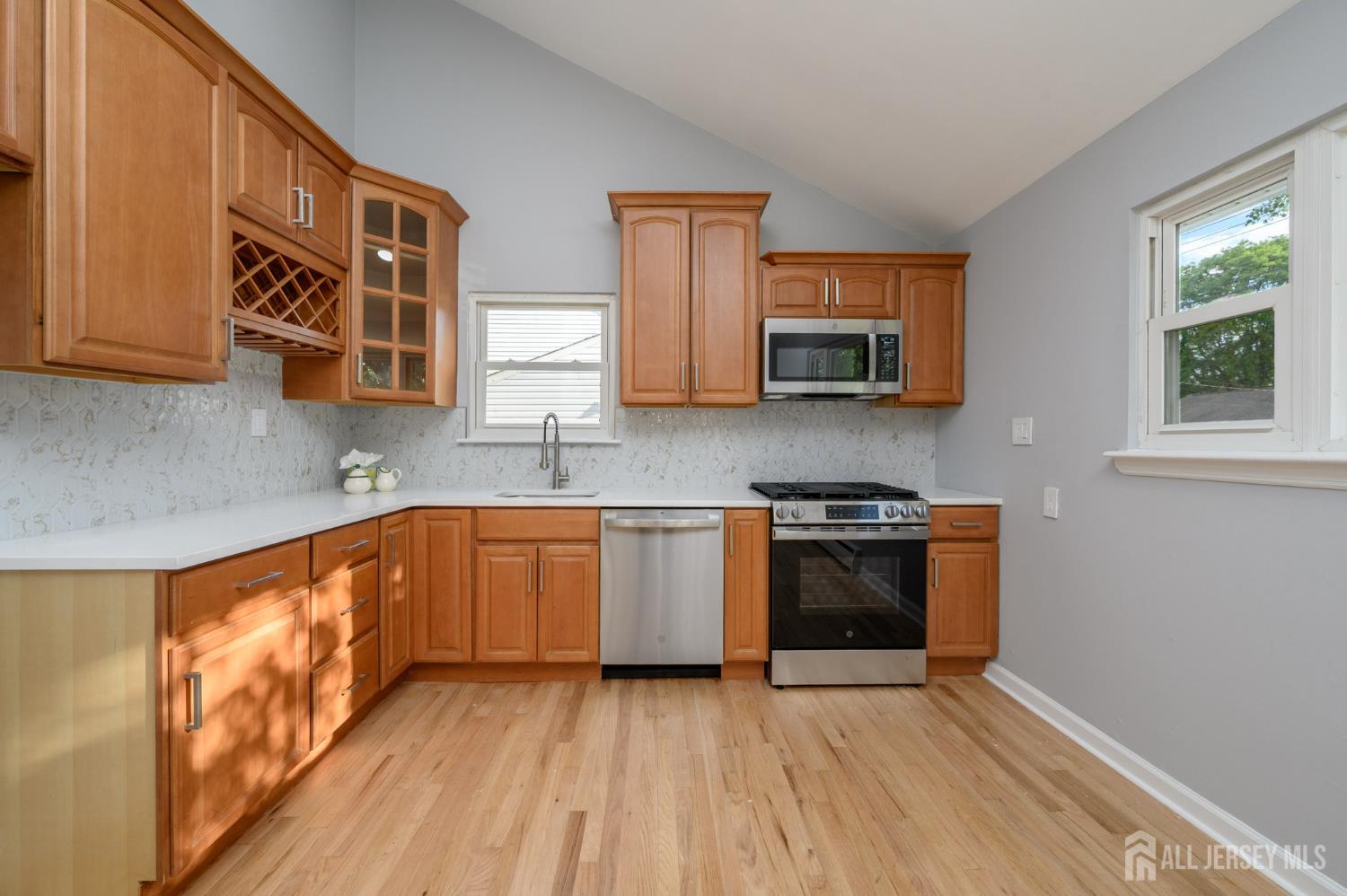 56 Drake Place Colonia, NJ 07067 - Photo 6 of 31 a kitchen with stainless steel appliances granite countertop a stove and a sink