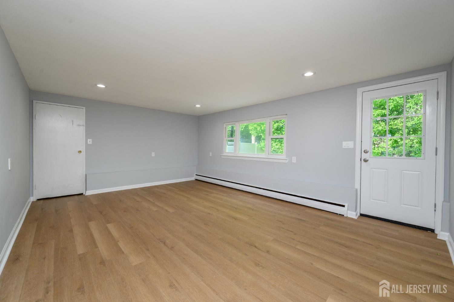 56 Drake Place Colonia, NJ 07067 - Photo 9 of 31 an empty room with wooden floor and windows