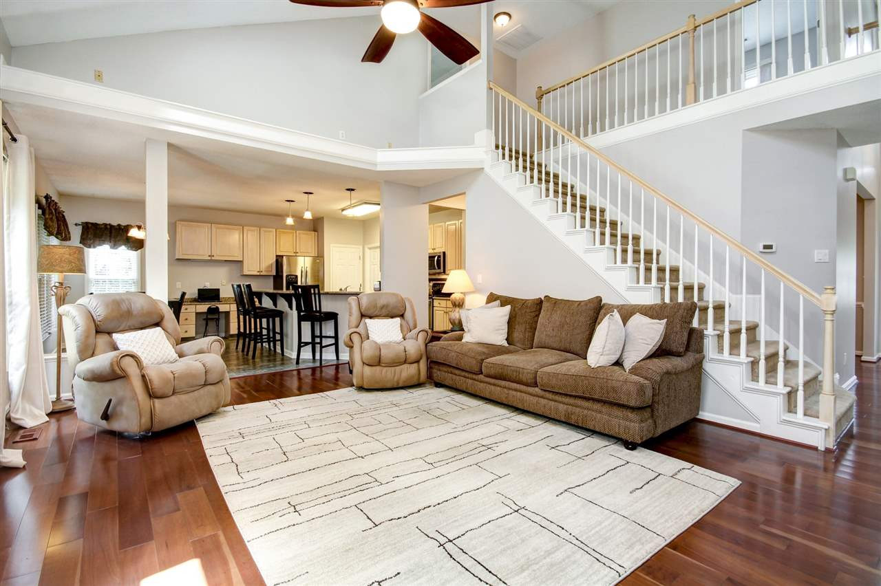 12305 Amoretto Way Raleigh, NC 27613 - Photo 12 of 30 Soaring ceilings showcase your large family room with gas fireplace and the Brazilian Cherry floors continue through. Great view of the large landscaped yard that is fenced in for privacy. Family Room