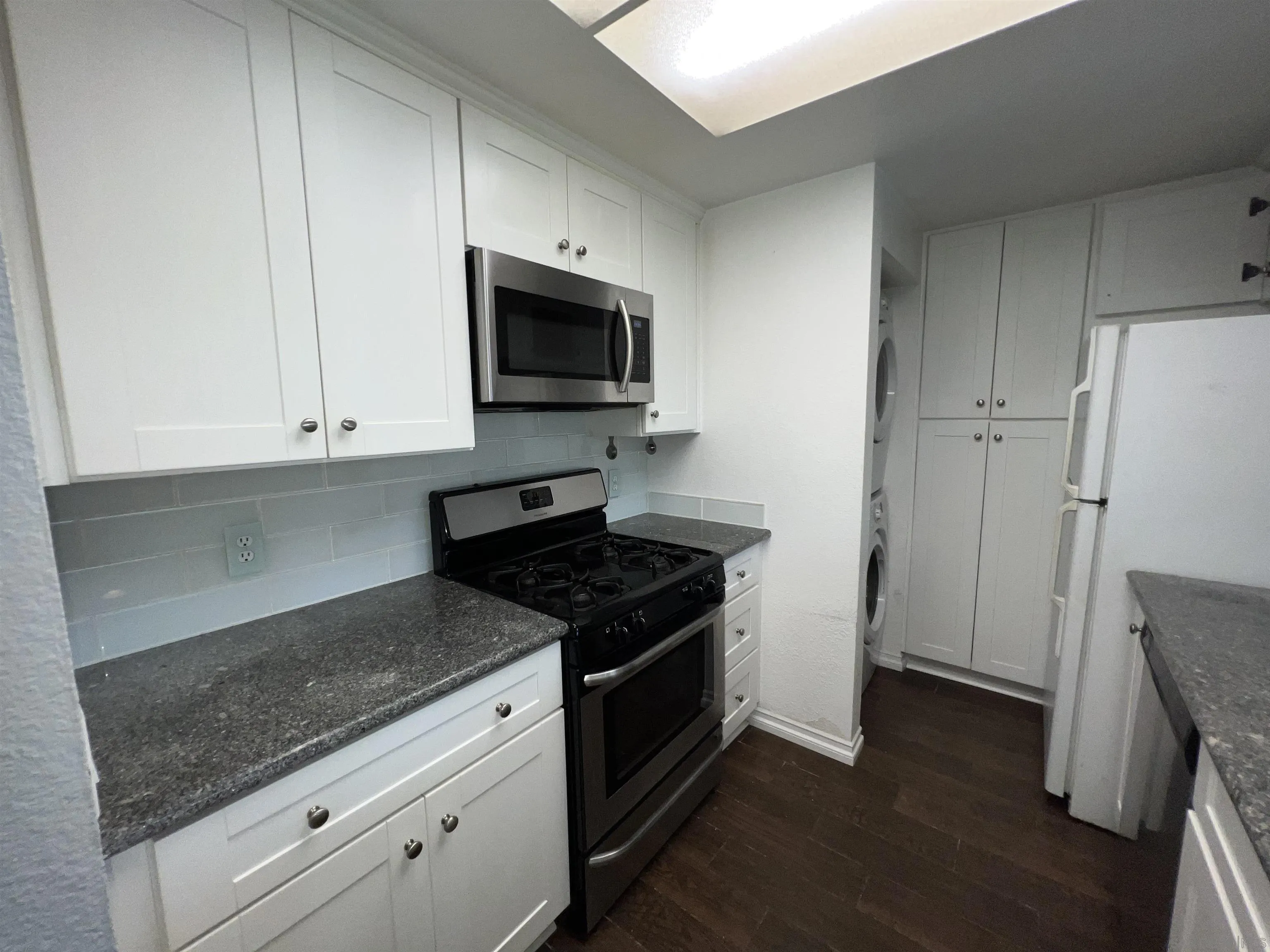 3043 Chipwood Court Spring Valley, CA 91978 - Photo 11 of 38 a kitchen with granite countertop white cabinets and stainless steel appliances
