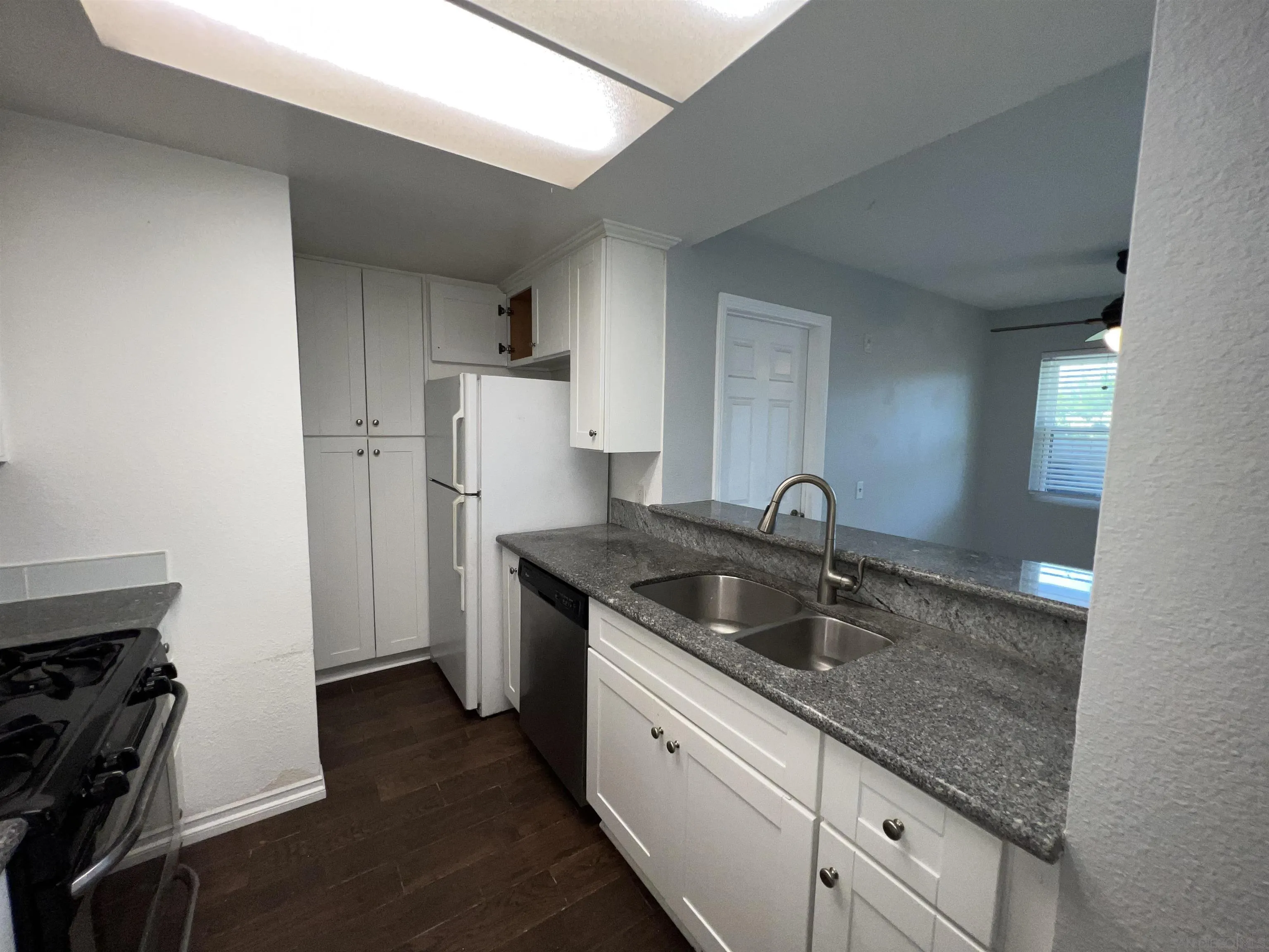 3043 Chipwood Court Spring Valley, CA 91978 - Photo 12 of 38 a kitchen with stainless steel appliances granite countertop a sink stove and refrigerator