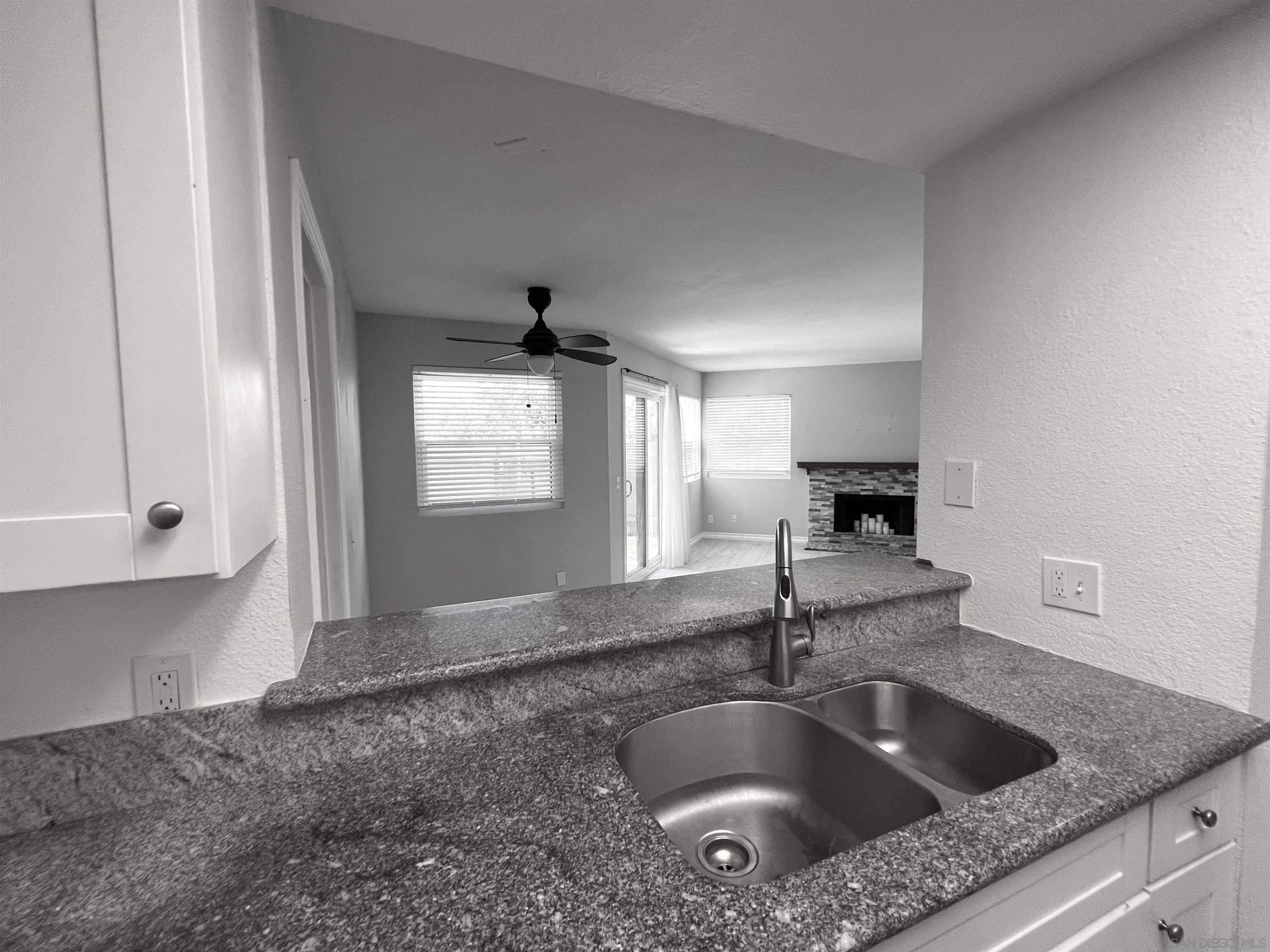 3043 Chipwood Court Spring Valley, CA 91978 - Photo 15 of 38 a kitchen with kitchen island a sink granite counter tops and a window