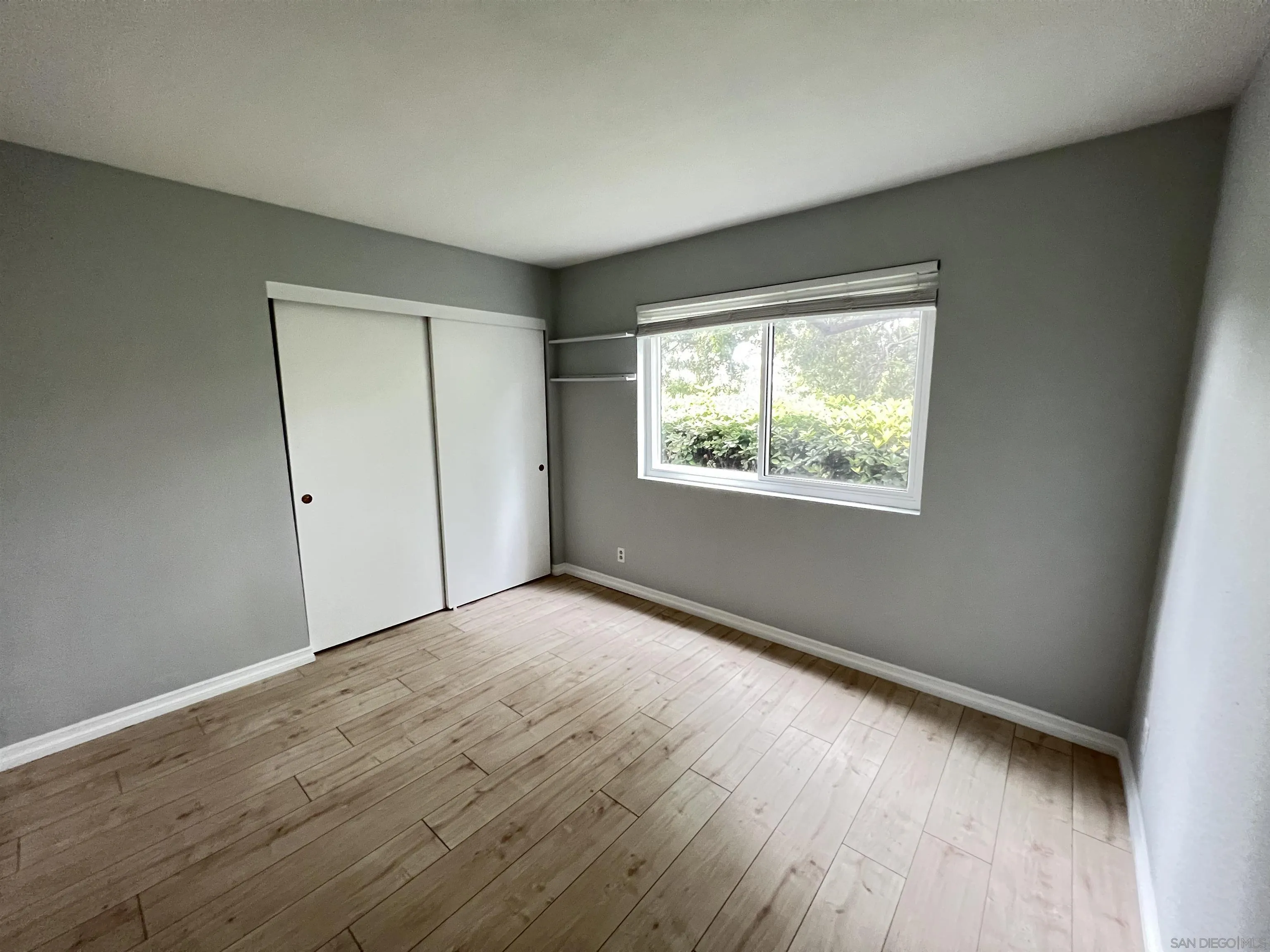 3043 Chipwood Court Spring Valley, CA 91978 - Photo 17 of 38 an empty room with wooden floor and windows