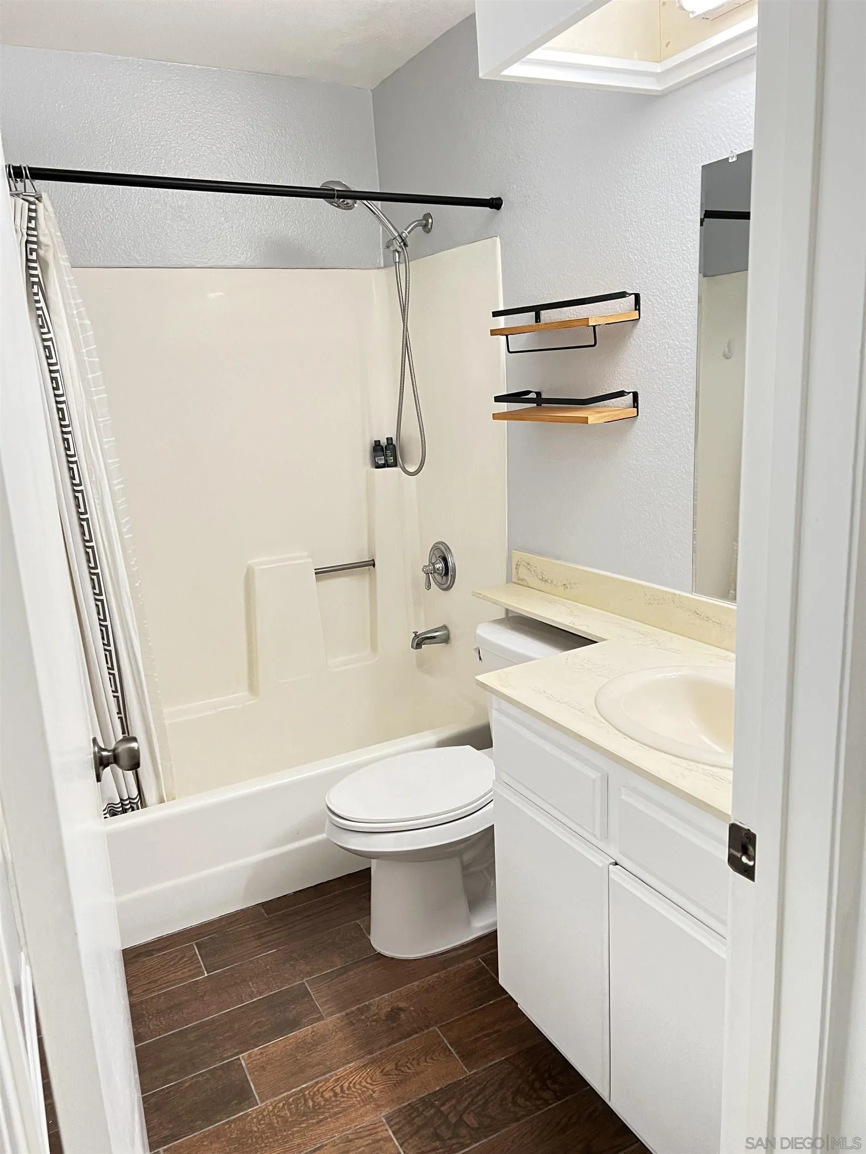 3043 Chipwood Court Spring Valley, CA 91978 - Photo 18 of 38 a bathroom with a white toilet a sink and a bathtub
