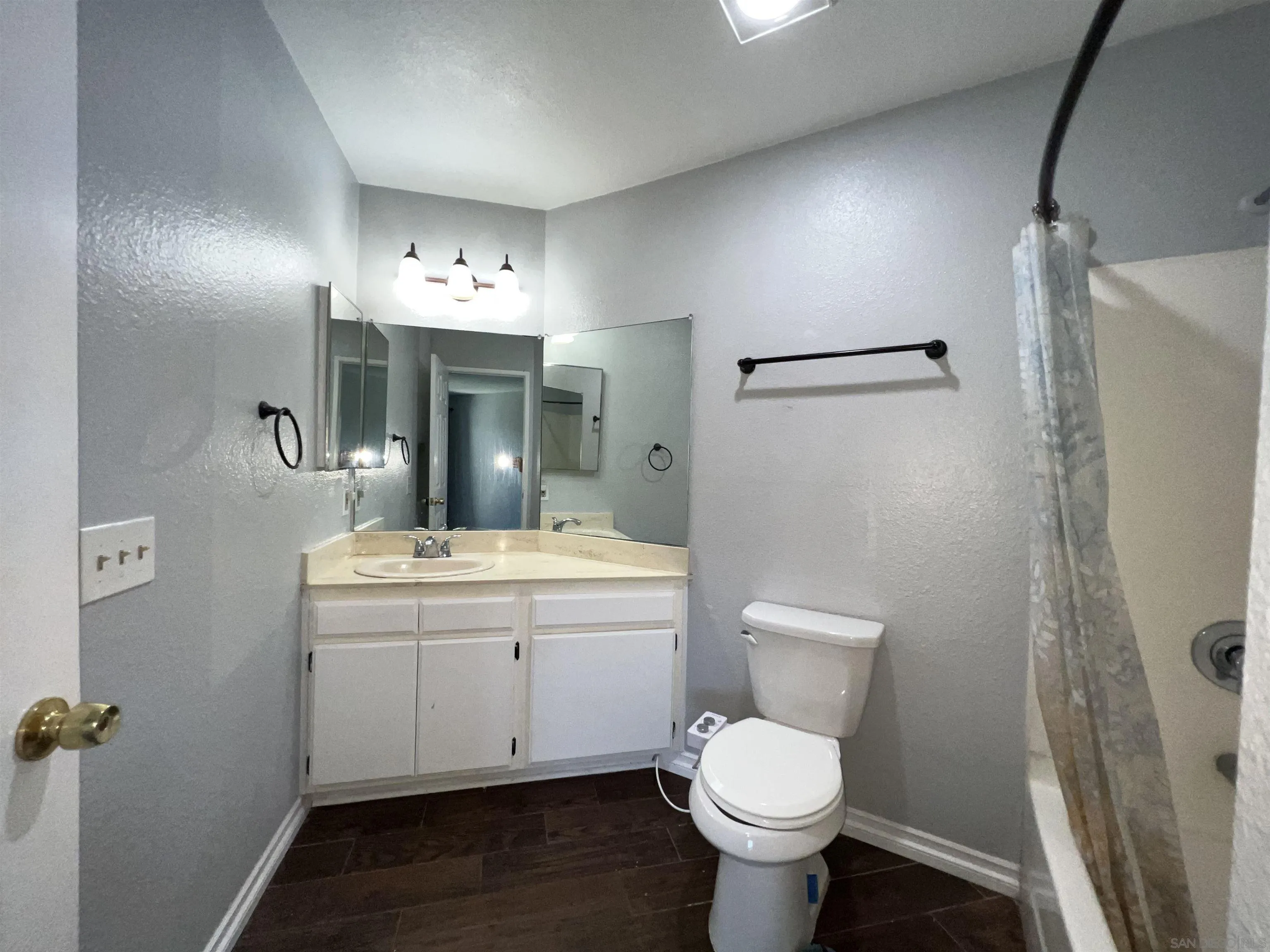 3043 Chipwood Court Spring Valley, CA 91978 - Photo 24 of 38 a bathroom with a toilet sink and mirror