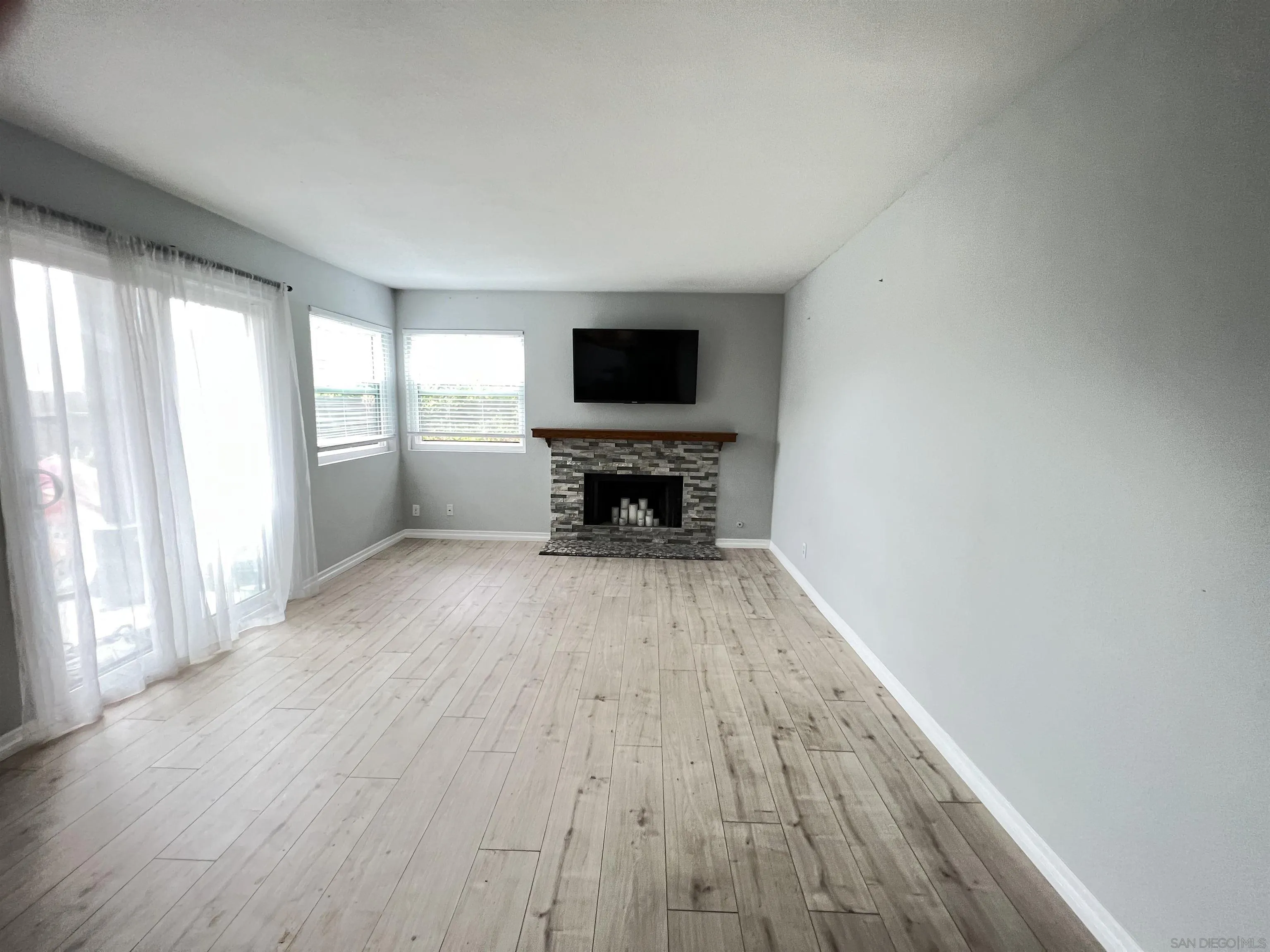 3043 Chipwood Court Spring Valley, CA 91978 - Photo 3 of 38 a view of empty room with wooden floor and fireplace
