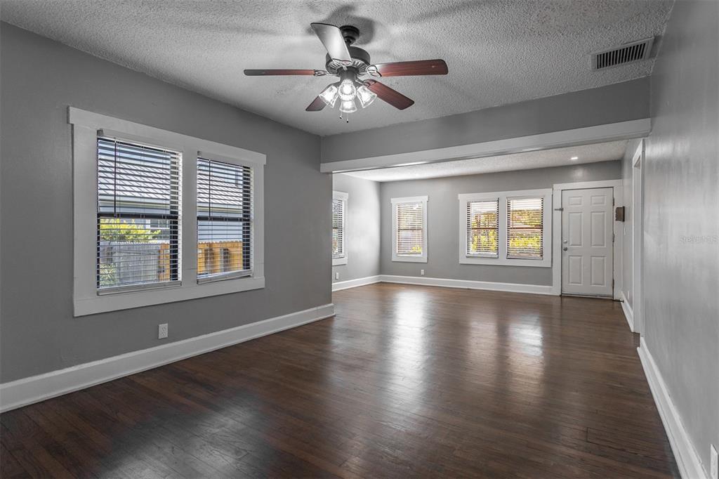 448 24th Street North St. Petersburg, FL 33713 - Photo 2 of 9 a view of an empty room with a window and wooden floor