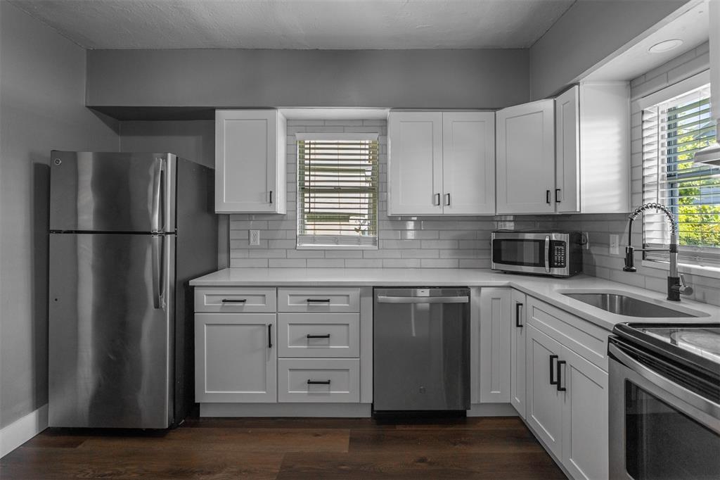 448 24th Street North St. Petersburg, FL 33713 - Photo 4 of 9 a kitchen with appliances a sink and a window