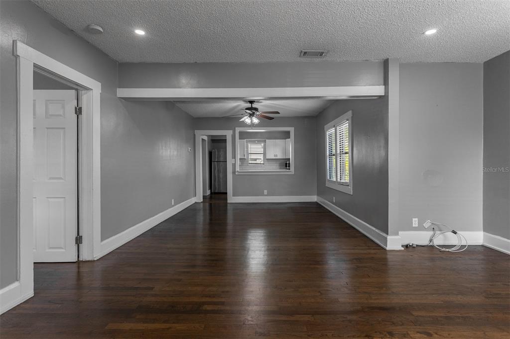 448 24th Street North St. Petersburg, FL 33713 - Photo 6 of 9 an empty room with wooden floor and windows