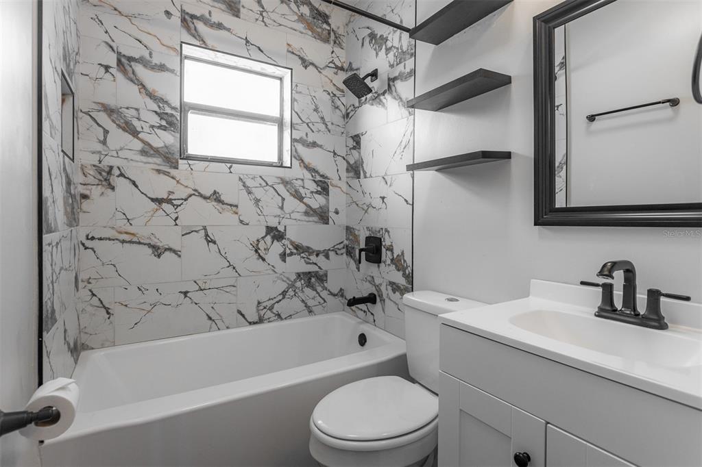 448 24th Street North St. Petersburg, FL 33713 - Photo 7 of 9 a bathroom with a sink a toilet and a bathtub