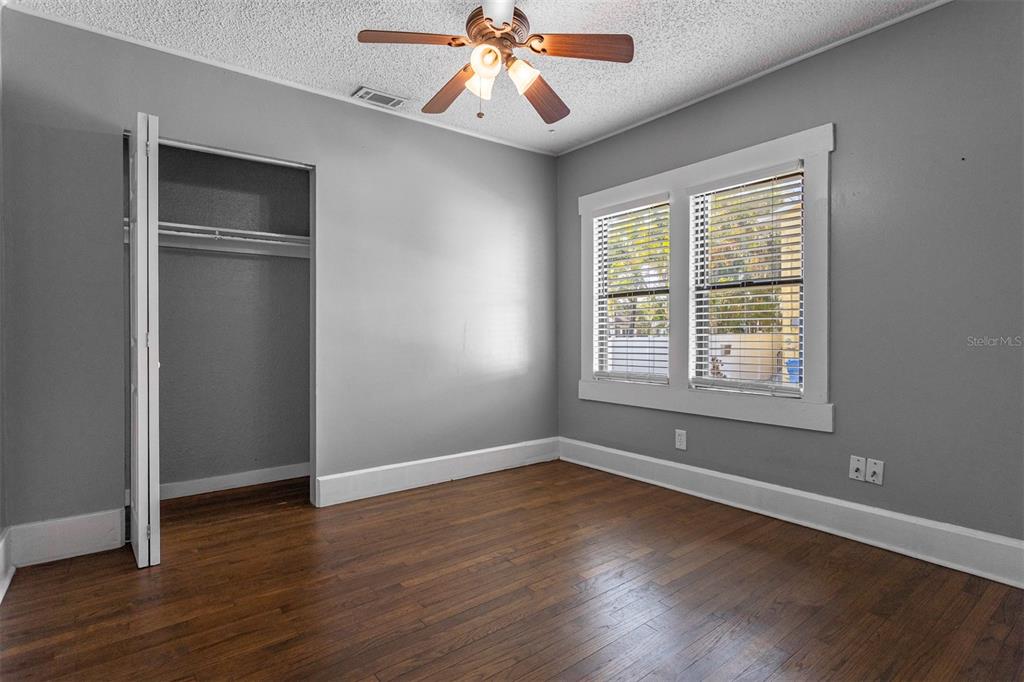 448 24th Street North St. Petersburg, FL 33713 - Photo 8 of 9 an empty room with wooden floor chandelier and windows