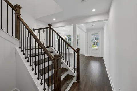 a kitchen with stainless steel appliances kitchen island granite countertop a table chairs stove and refrigerator