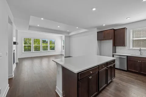 a kitchen with kitchen island a sink and wooden cabinets