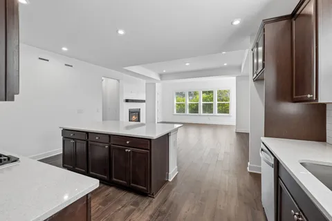 an empty room with wooden floor and a fireplace