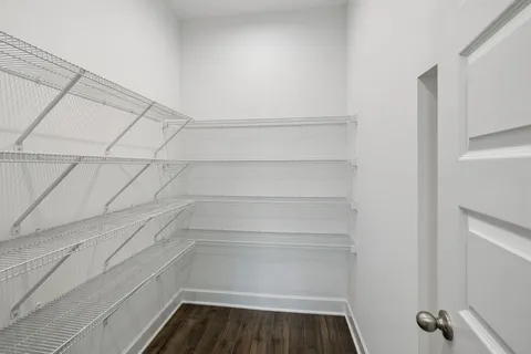an empty room with wooden floor and a fireplace