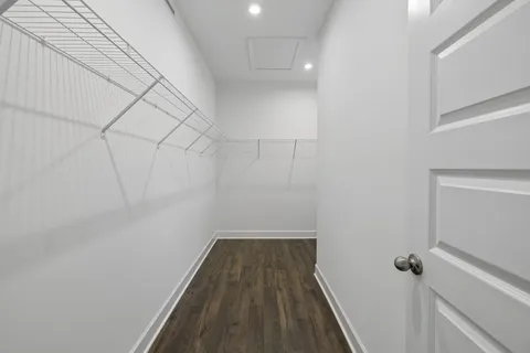a bedroom with a bed and a chair