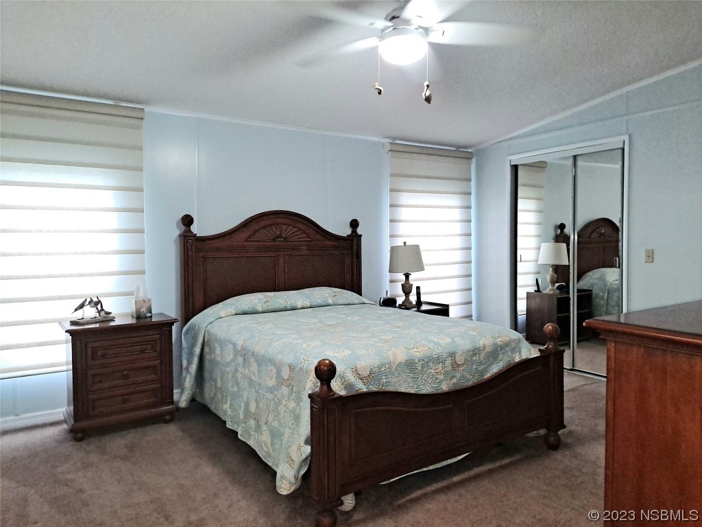 4330 Whiting Way Edgewater, FL 32141 - Photo 11 of 30 a bedroom with a bed and dresser with mirror