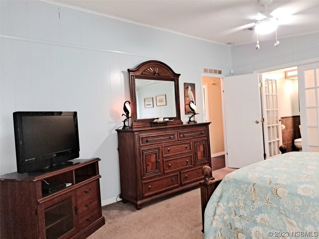 4330 Whiting Way Edgewater, FL 32141 - Photo 12 of 30 a bedroom with a bed and a flat screen tv