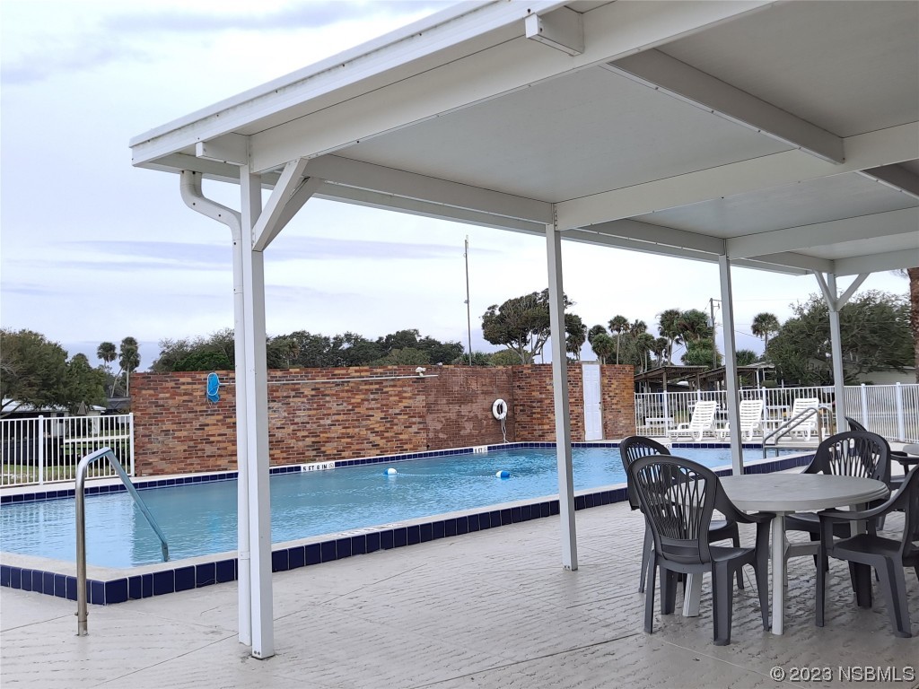 4330 Whiting Way Edgewater, FL 32141 - Photo 24 of 30 a view of a patio with a table chairs and a table