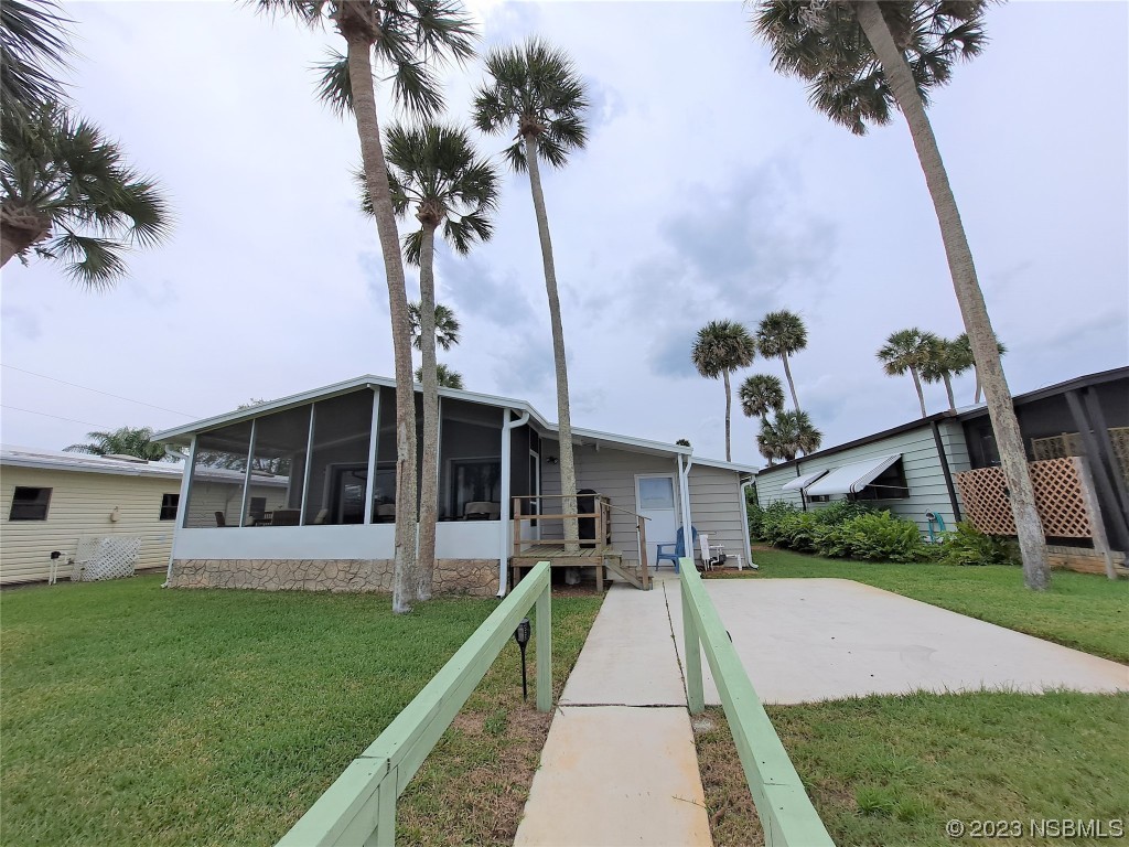 4330 Whiting Way Edgewater, FL 32141 - Photo 4 of 30 a front view of a house with a yard and potted plants